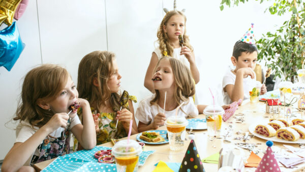 Girl birthday decorations. table setting with cakes, drinks and party gadgets.